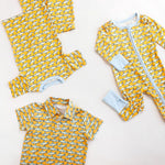 Children's clothing set with orange and blue fish pattern on a white background