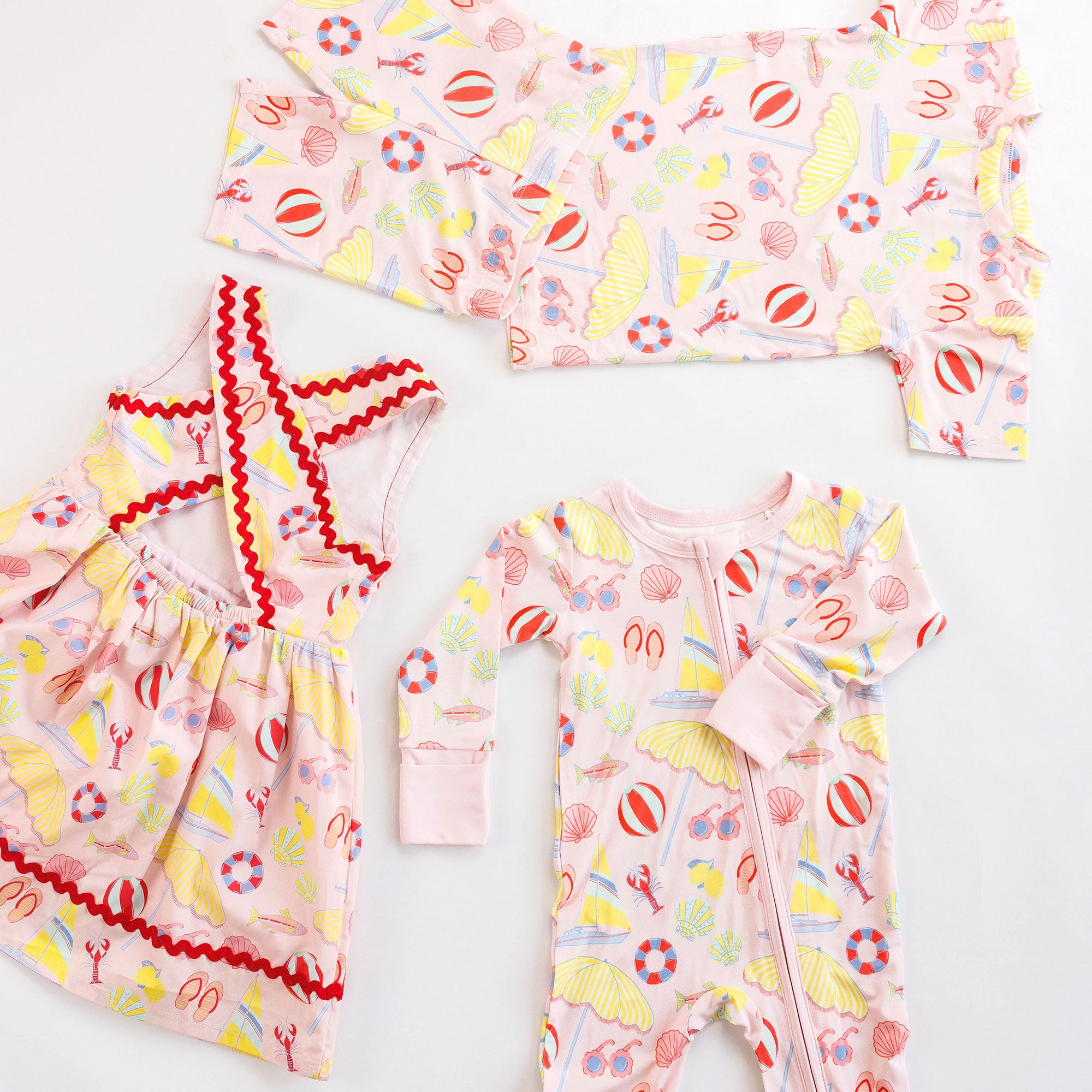Children's dress, loungewear set, and zipper romper with colorful patterns on a white background