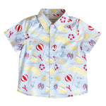 Children's shirt with beach-themed pattern on a white background