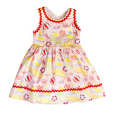 Colorful children's dress with beach-themed pattern on a white background