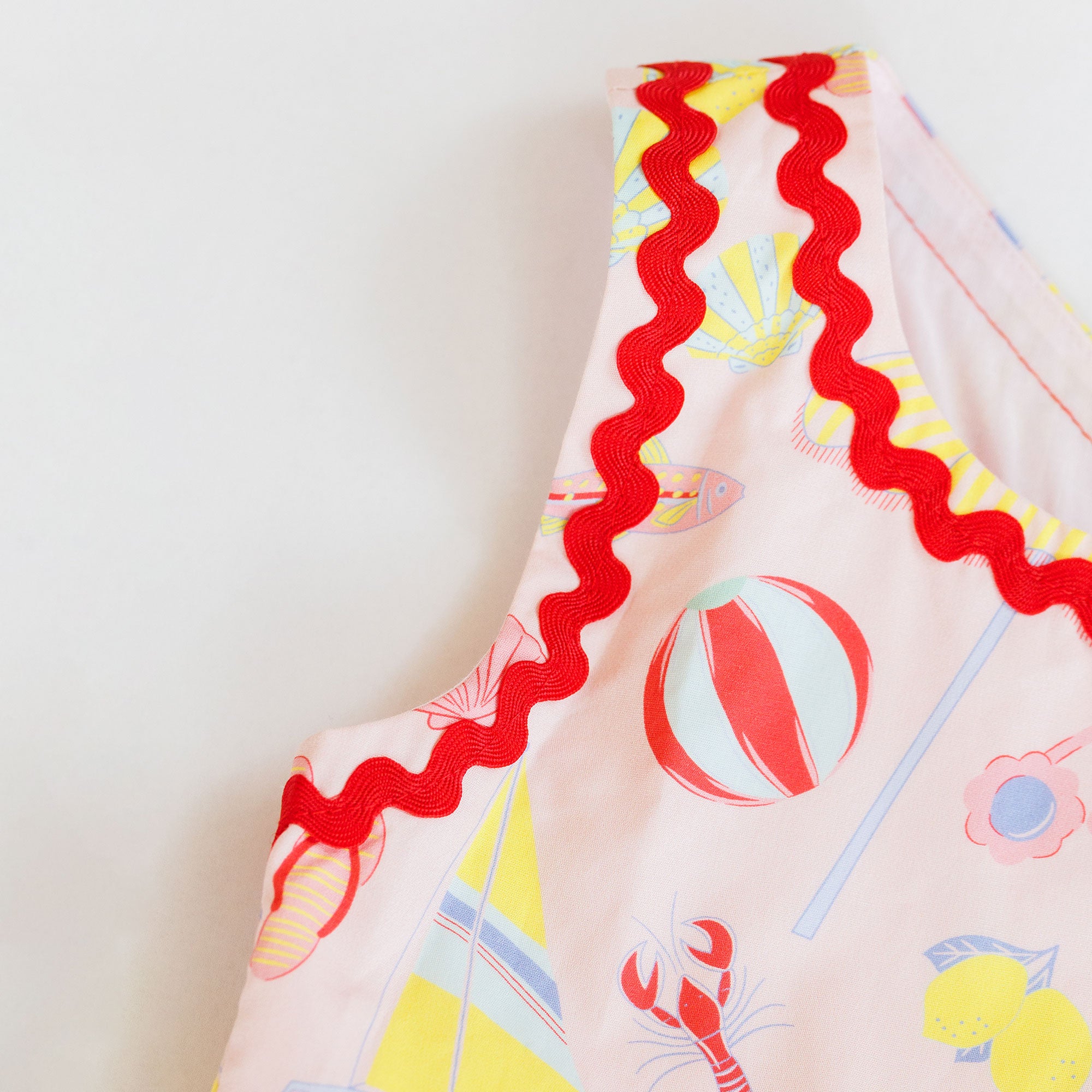 Colorful fabric with beach-themed patterns on a light background
