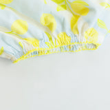 Close-up of a bubble with yellow floral pattern on a light gray background