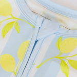 Light blue fabric with yellow lemon pattern on a white background