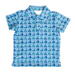 Blue polo shirt with sailboat pattern on a light gray background
