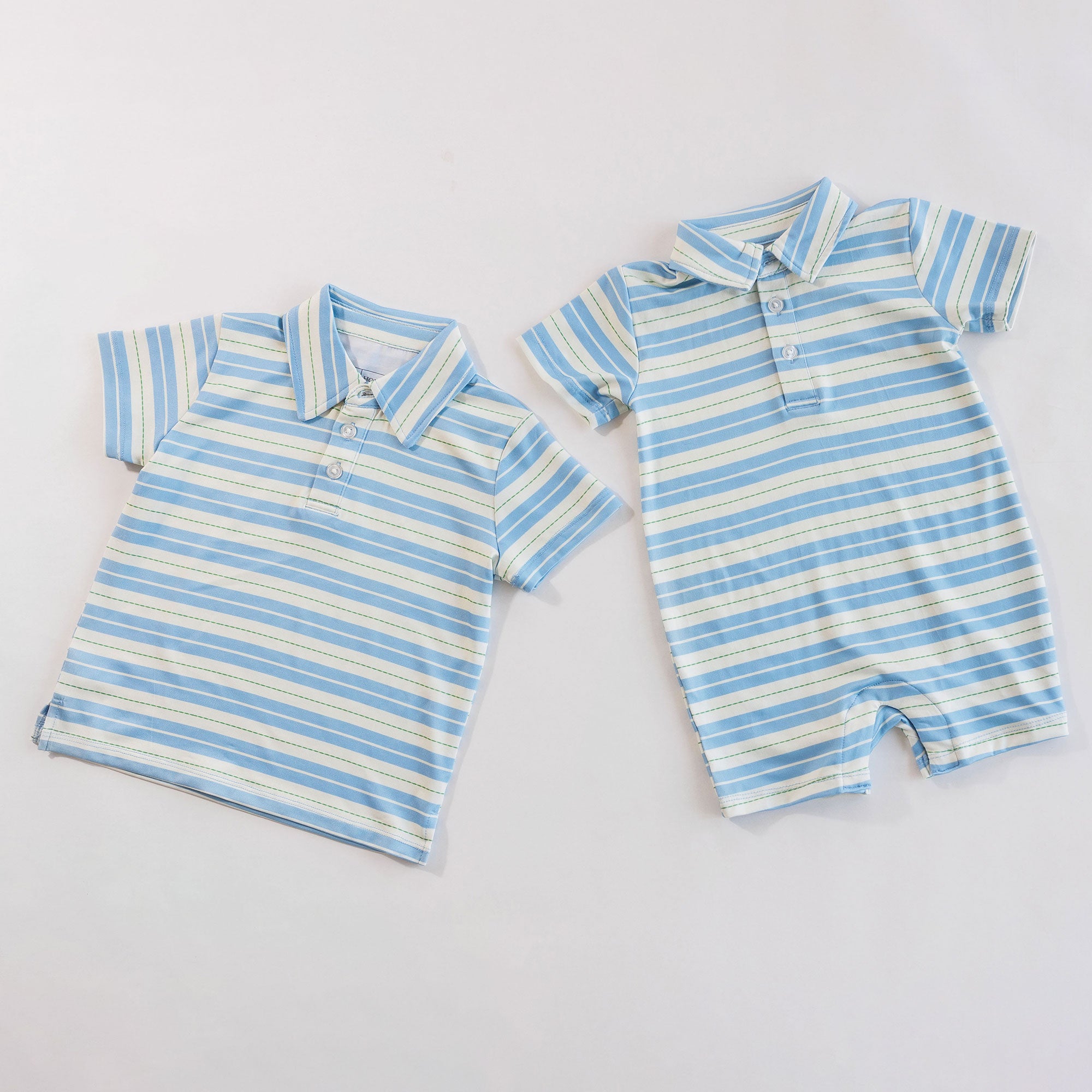 Striped children's shirt and romper set on a light gray background
