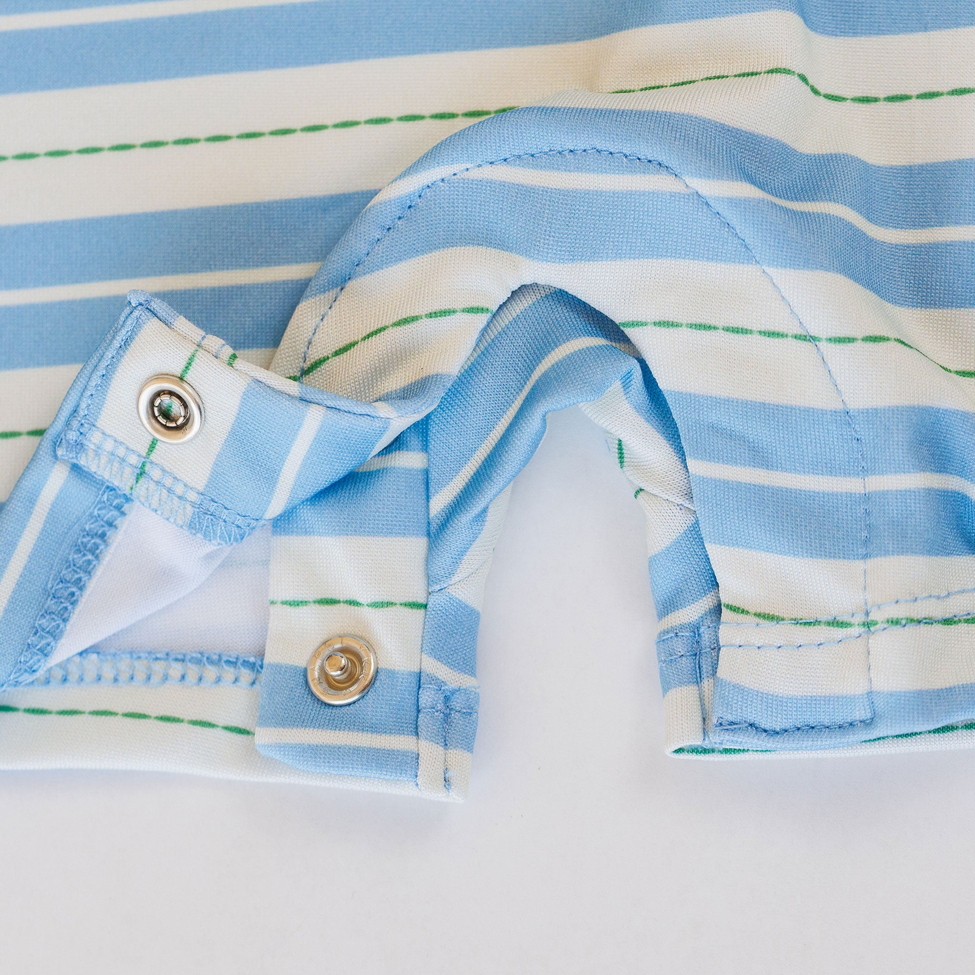 Snaps on baby romper with blue, green, and white stripes