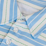 Close-up of a blue and white striped shirt with a button detail.